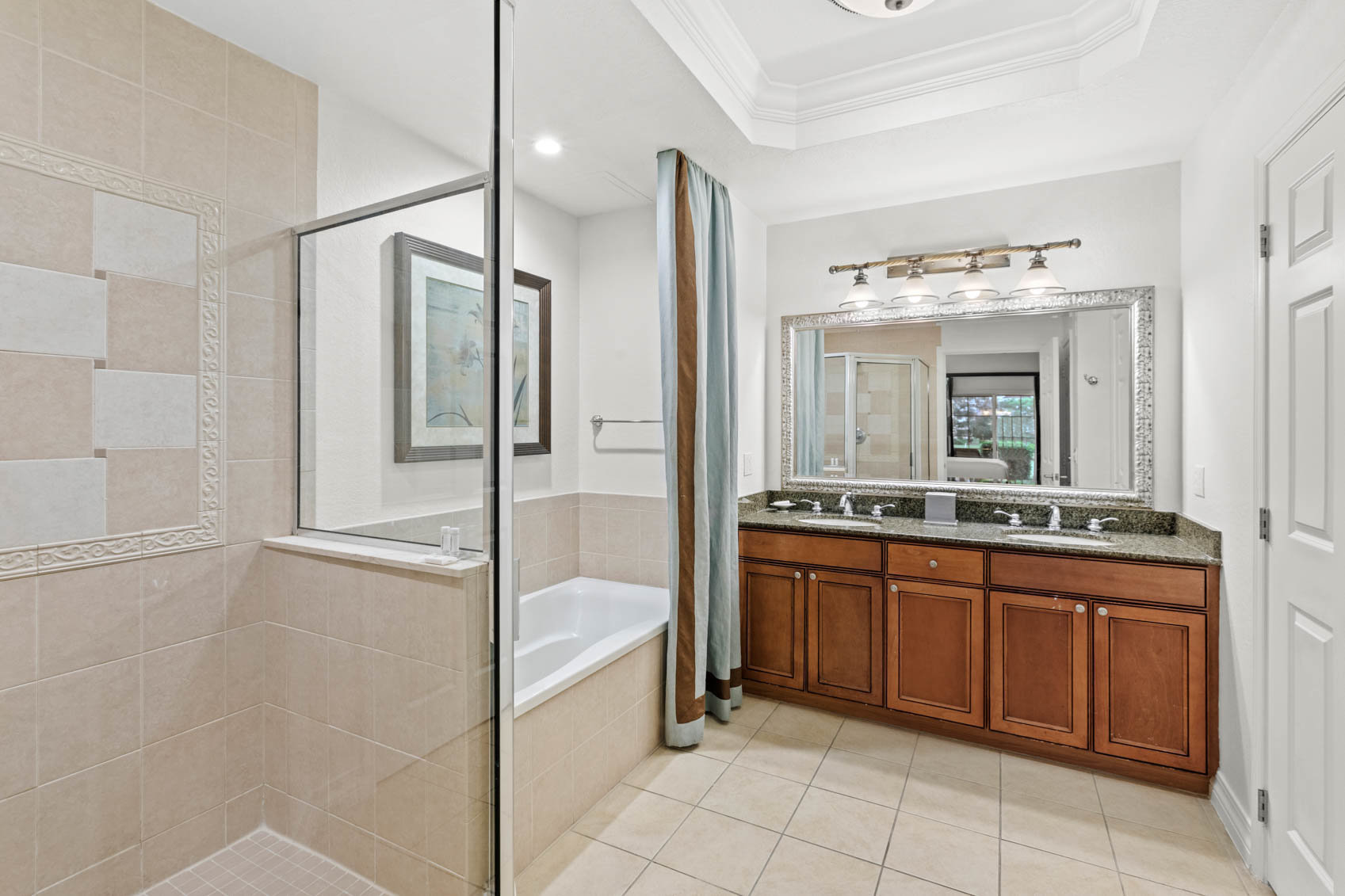 primary bathroom with dual sinks and walk in shower